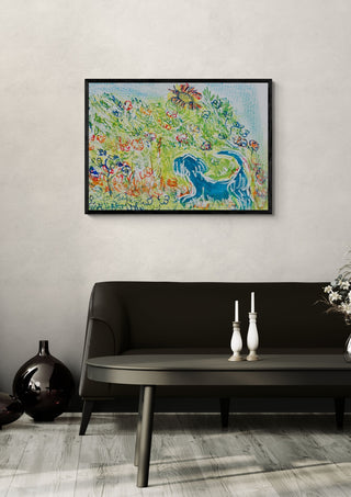 Blue Cat in the Garden by Eva Hartman in a black frame above a dark sofa with white candlesticks