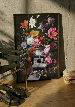 Floral Instant Photo by Dikhotomy in a black frame leaning against a concrete wall by a steel chair