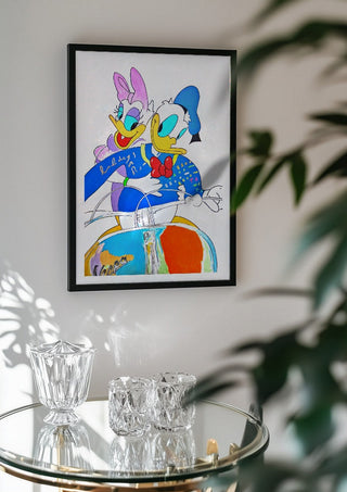 Vacanze Romane (Pop-surrealist take) by NKo in a black frame above a glass table with crystal glassware