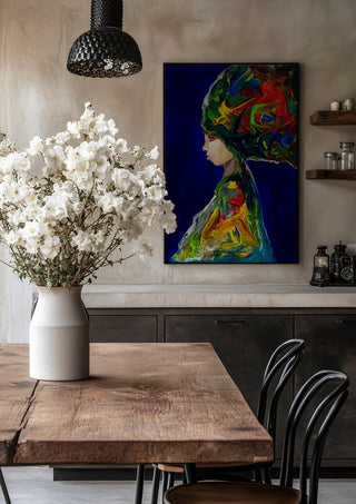 The Wind by Ronny Simon in a black frame above a rustic table with white flowers
