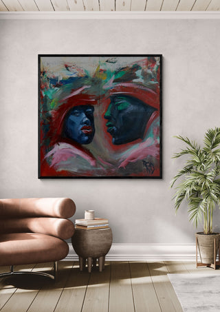 Meeting in Red by Ronny Simon in a black frame above a pink armchair beside a palm