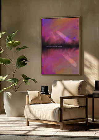 Easily distracted by everything by Astrid Lind framed above a beige armchair beside a potted plant