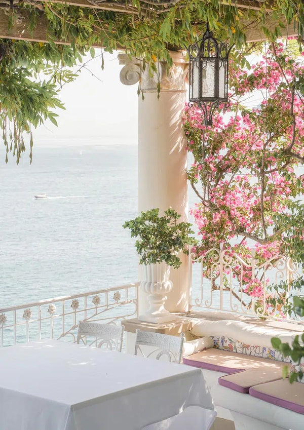 Terrace with flowers and sea view, shaded seating area under pergola at Sorrento Vibes.