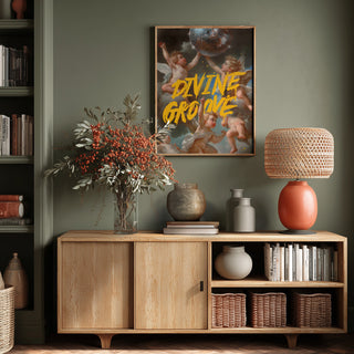 Poster for Divine Groove - Dikhotomy on a wall above a wooden sideboard with vases, lamp, and books.