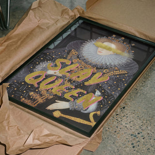 Framed Slay Queen Portrait - Talitha McQueen, in ornate attire, partially wrapped in brown paper on concrete floor.