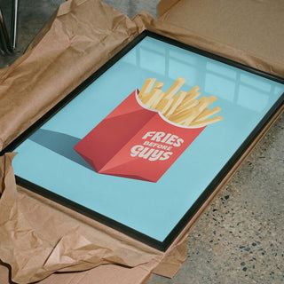 Framed "Fries Before Guys" print by Andreas Magnusson in packaging, featuring fries in a red box on blue background.