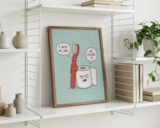 Framed "Grumpy Bathroom Talk" art by Andreas Magnusson on shelf, with talking toothbrush and toilet paper.