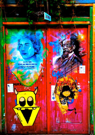 Graffiti Door by Pelecan Schneider - red London door covered in spray-painted portraits, a yellow monster and tags