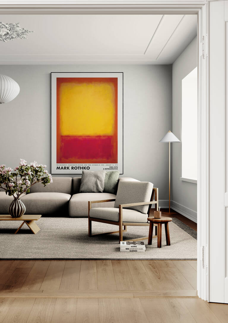 Framed Rothko Yellow on Red poster hanging above a beige sofa in a modern living room.