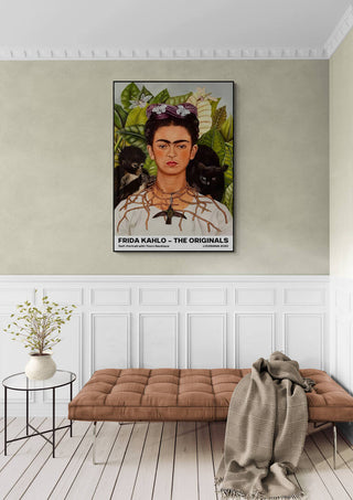 Frida Kahlo Thorn Necklace art print displayed above a bench in an elegant, softly lit room.