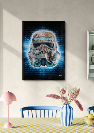 A framed "Dont Ask Permission" artwork by Ricardo Noble hangs above a table with flowers in a bright room.