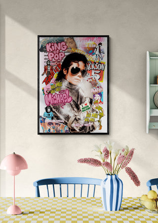 Framed "Michael Jackson - Ricardo Noble" pop art poster hanging above a dining table with flowers.