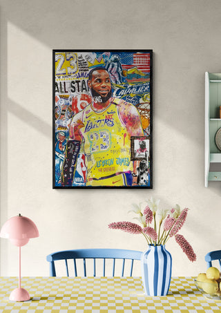 Framed "Lebron" artwork by Ricardo Noble displayed on a beige wall above a dining table with flowers.
