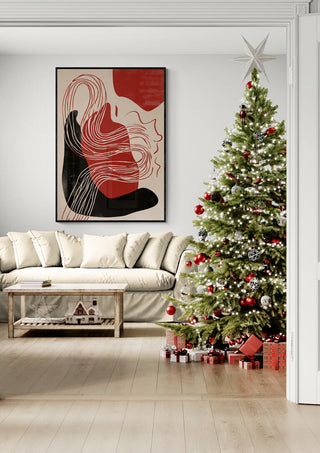 Modern living room with a Christmas tree, presents, and abstract art on the wall in festive holiday decor.