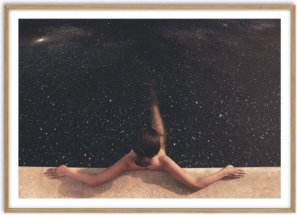 Holynight by Fran Rodriguez - a figure lying with arms outstretched on pale sand under a field of stars