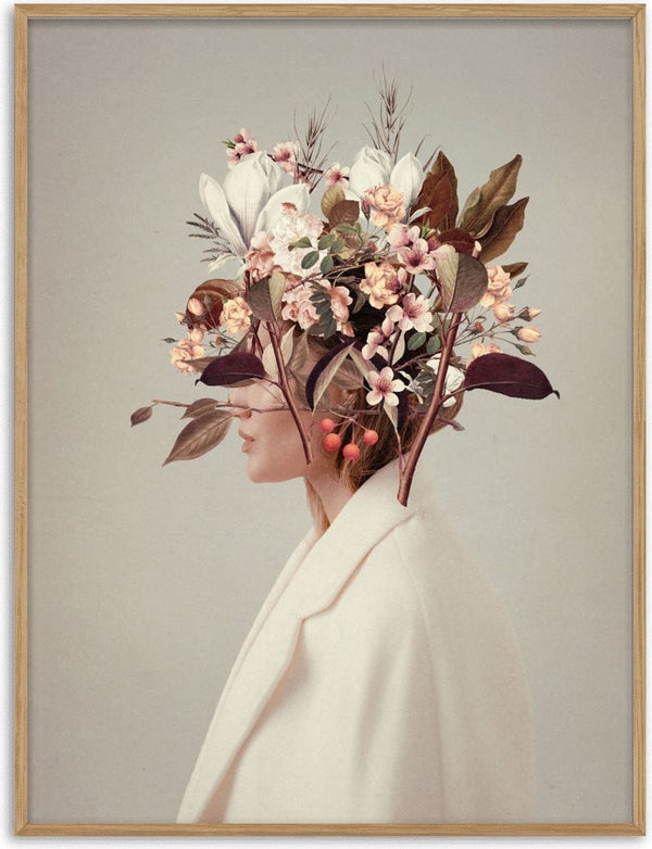 Surreal portrait of a woman in white coat with autumn flowers and leaves blooming from her head.