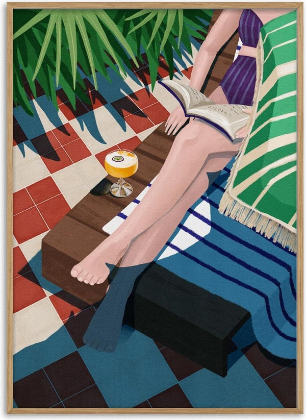 Woman reading on a lounge chair with a drink nearby, featured for Just one more chapter - Goed Blauw.