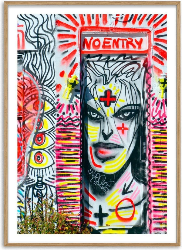 Colorful street art poster featuring a bold "NO ENTRY" sign with abstract faces and vivid graffiti patterns.