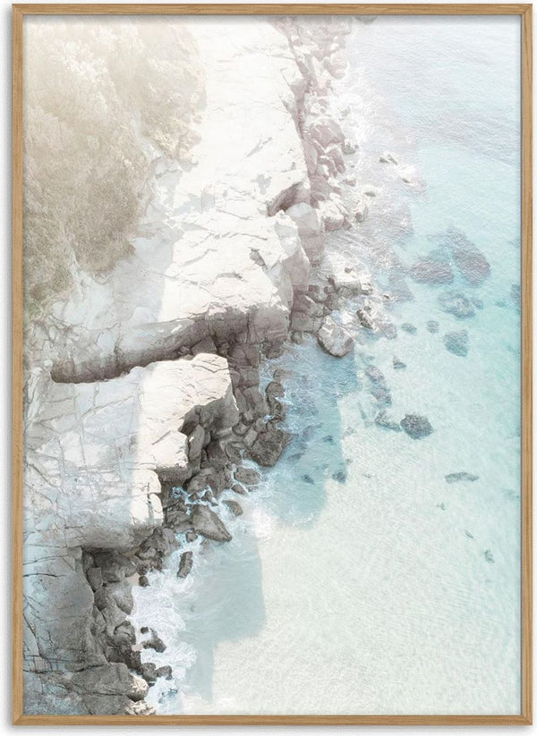 Aerial view of a rocky beach with turquoise water featured on the Rocky Beach Plakat product page.