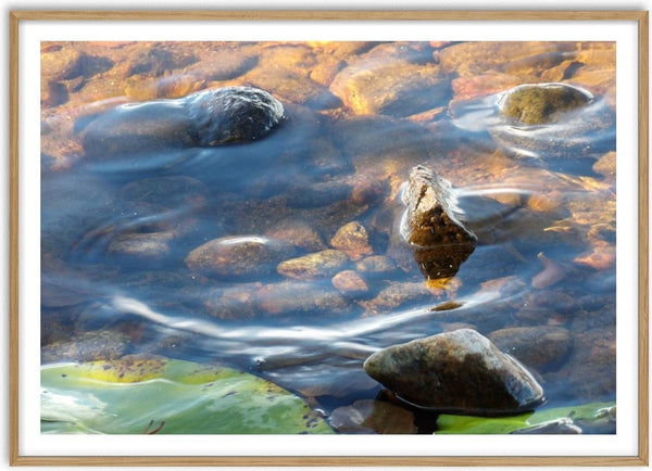 Sommar brus by Ljilja Marinic - sunlit water running over smooth stones with green lily pads